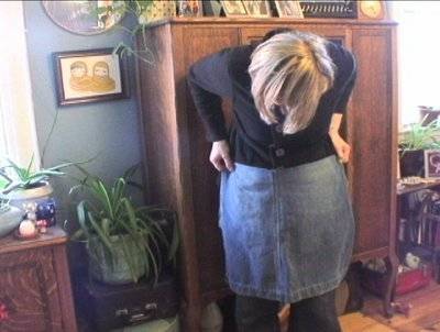 " A woman checks and tries to match an Apron out of old jeans "