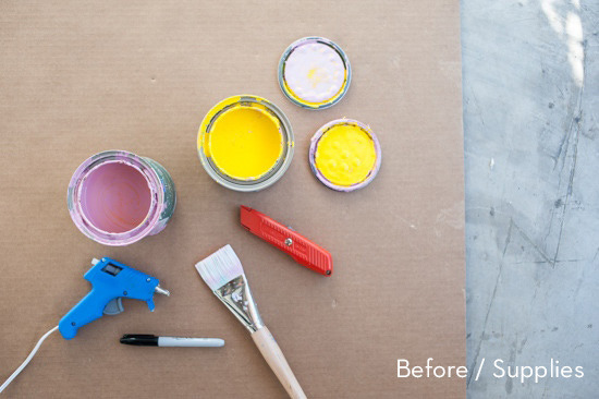 Yellow and pink colored tins, glue gun, paint brush, saw blade and cardboard for diy.