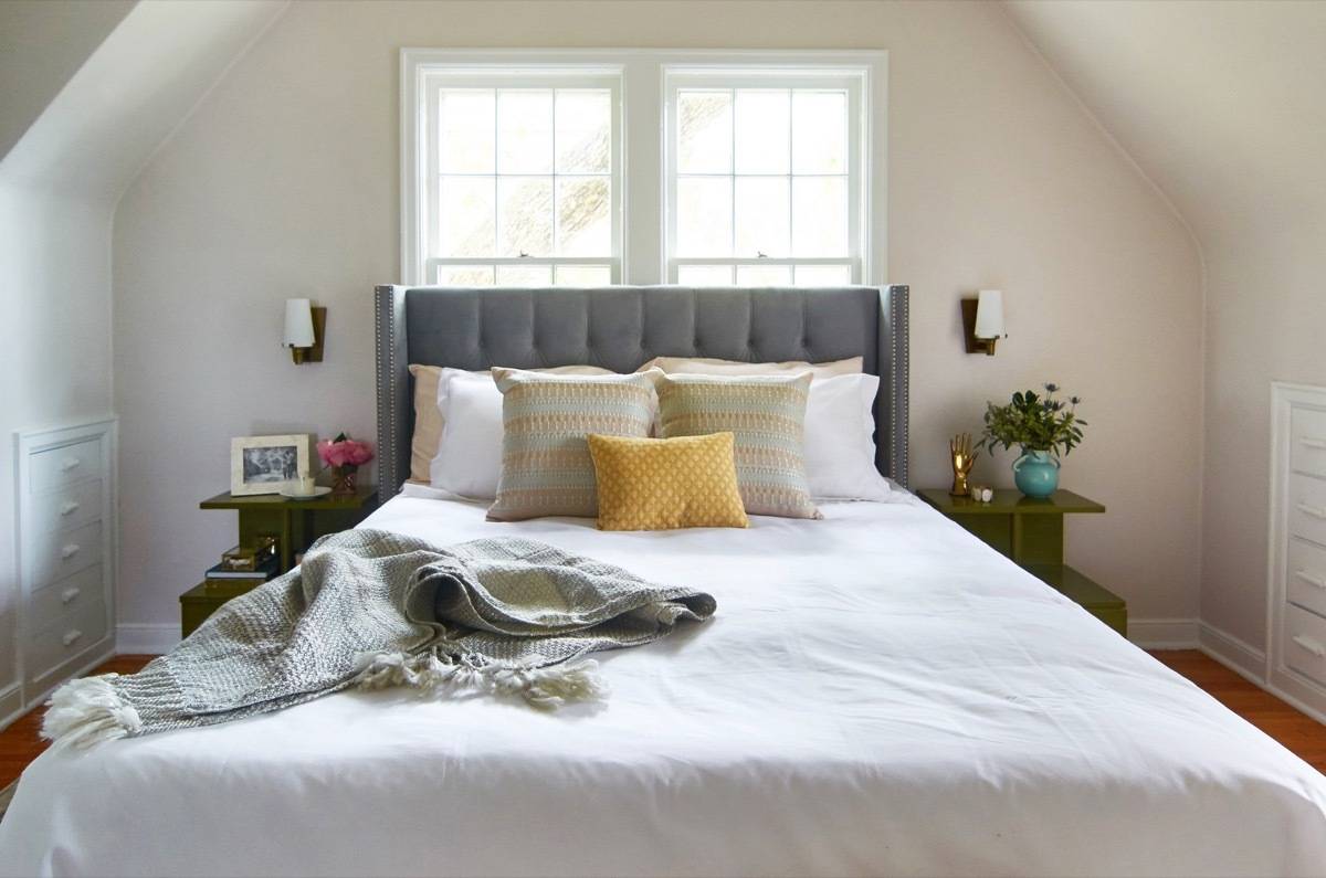 Curbly House master bedroom - upholstered headboard and vintage tables
