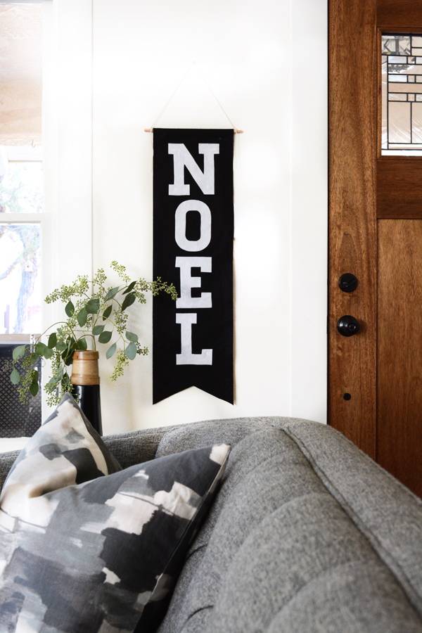 A cozy grey couch with a view of the door entrance