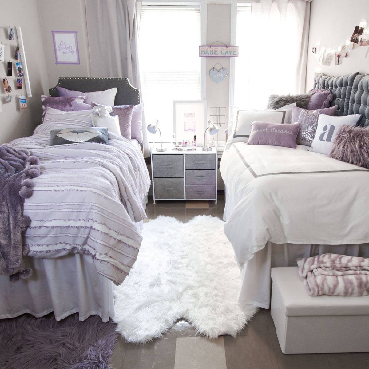 Two beds are separated by a lush rug.