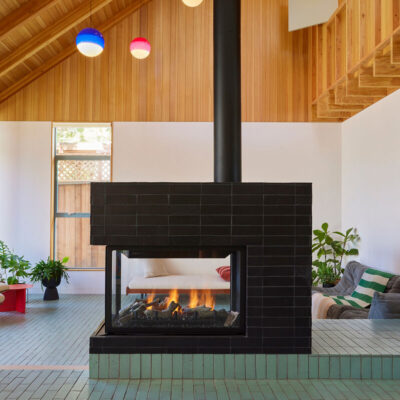 featured mid century fireplace with black and turquoise tiles.